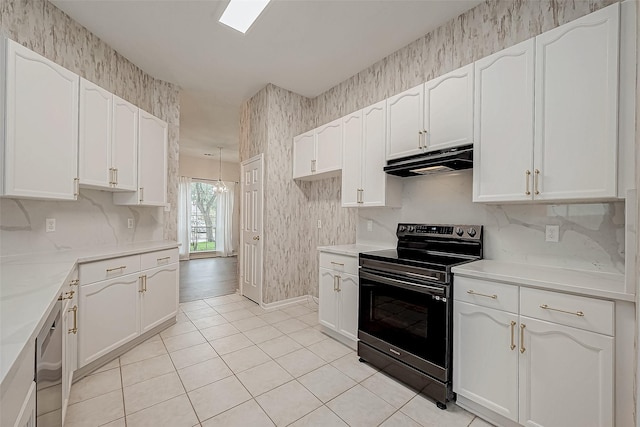 kitchen with electric range, white cabinetry, and light tile patterned floors