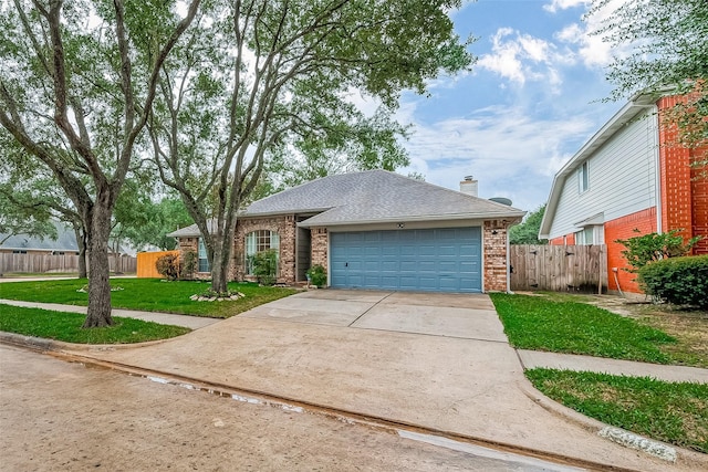 view of front of home with a front lawn and a garage