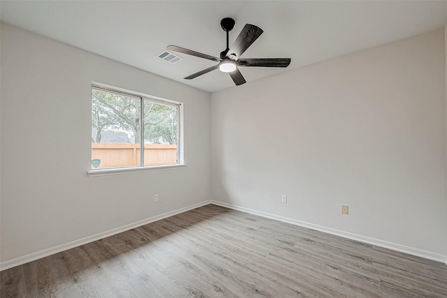 empty room with light wood-type flooring and ceiling fan