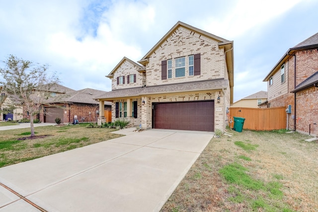 view of front of property with a front yard, a garage, and covered porch