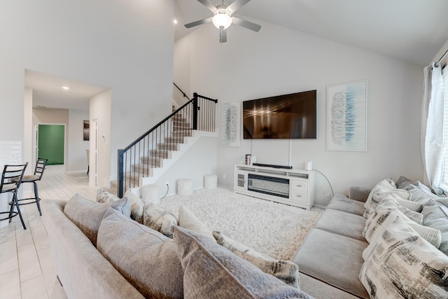 living room with high vaulted ceiling and ceiling fan