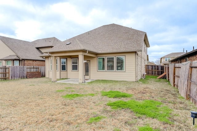 back of property featuring a yard and a patio area