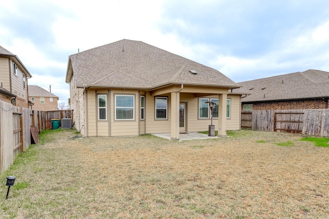 back of property featuring a yard, a patio area, and cooling unit