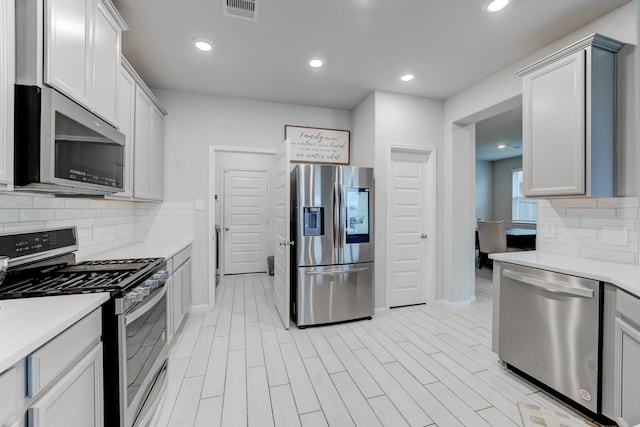 kitchen featuring appliances with stainless steel finishes and backsplash