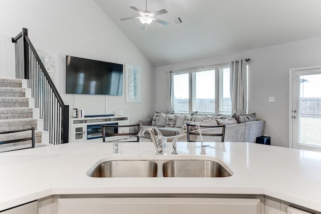 kitchen featuring plenty of natural light, ceiling fan, lofted ceiling, and sink