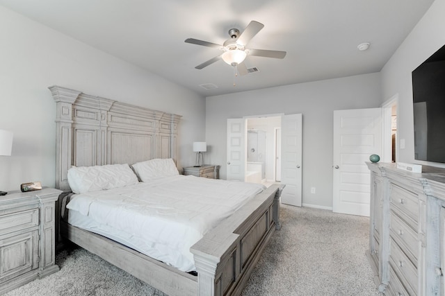 carpeted bedroom with ceiling fan and ensuite bath