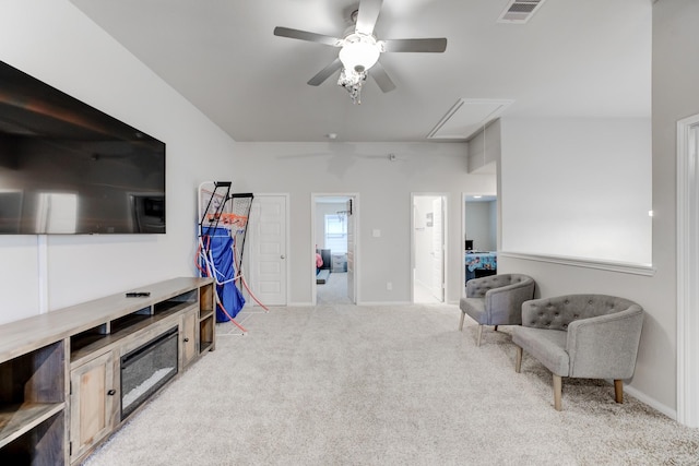 sitting room featuring ceiling fan and light colored carpet