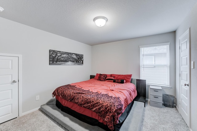 carpeted bedroom featuring a textured ceiling