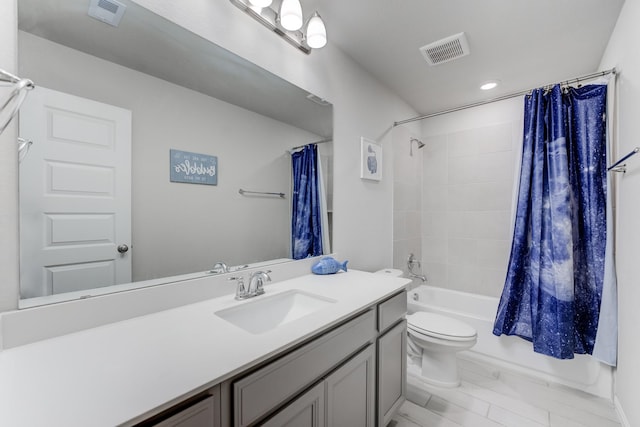 full bathroom with vanity, shower / bath combo with shower curtain, and toilet