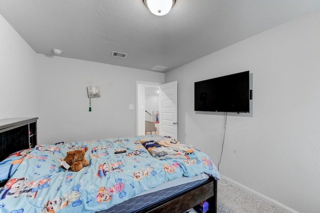 carpeted bedroom with a textured ceiling