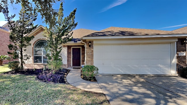 ranch-style home with a garage and a front lawn