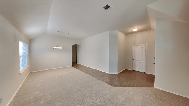 unfurnished room with vaulted ceiling and carpet