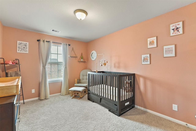 bedroom featuring carpet floors and a nursery area