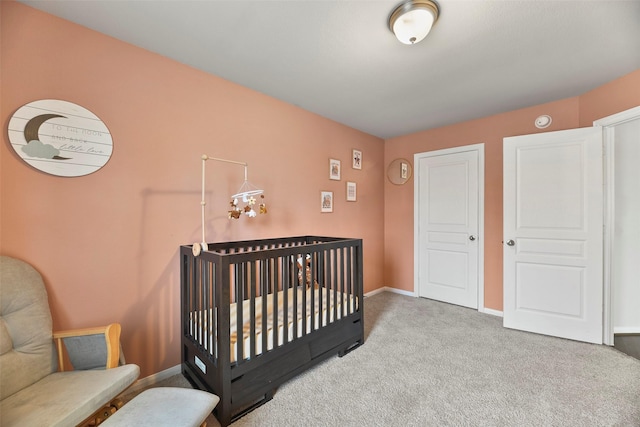 carpeted bedroom with a nursery area