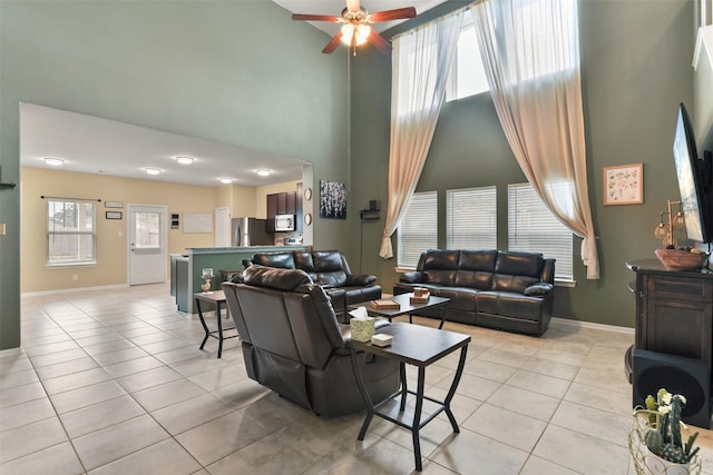 tiled living room featuring ceiling fan