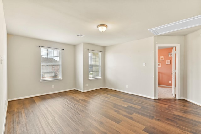 unfurnished room featuring dark wood-type flooring