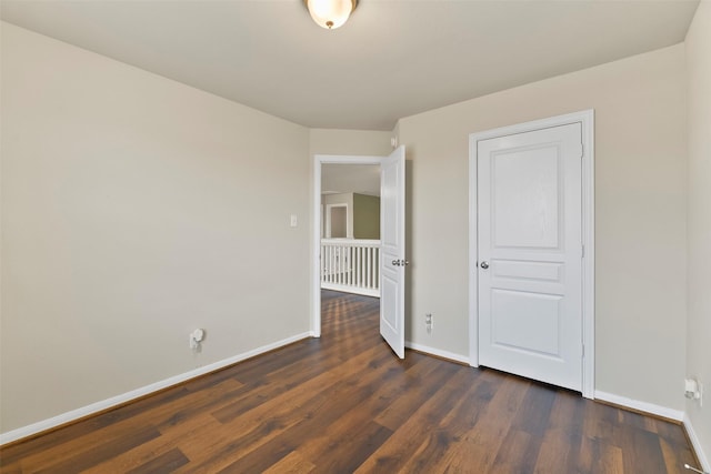 empty room featuring dark hardwood / wood-style flooring