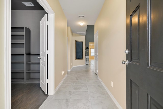 hallway featuring light tile patterned flooring