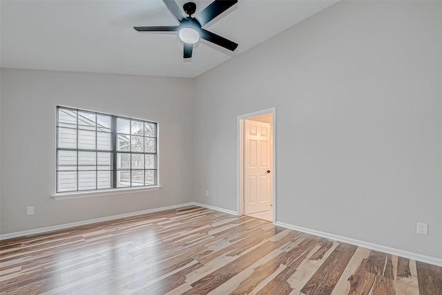 empty room with lofted ceiling, ceiling fan, and light hardwood / wood-style floors