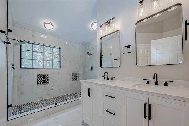 bathroom featuring tiled shower and vanity