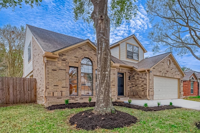 view of front of property with a front lawn and a garage