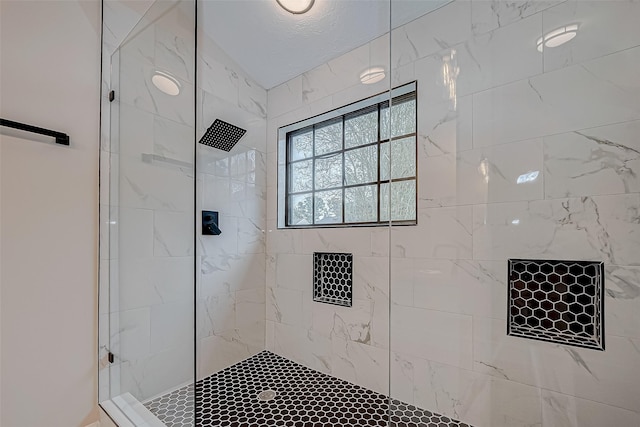 bathroom with tiled shower