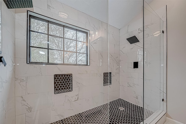 bathroom with tiled shower