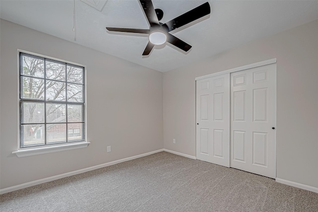 unfurnished bedroom featuring ceiling fan, a closet, and carpet floors