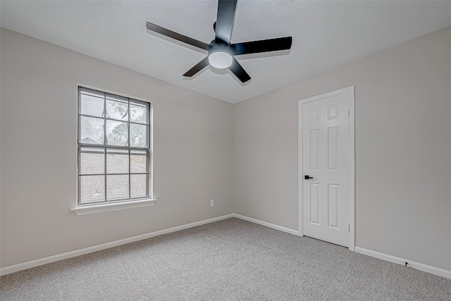 spare room with ceiling fan and carpet flooring