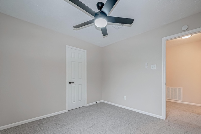 empty room featuring ceiling fan and carpet floors