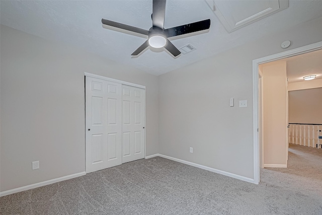 unfurnished bedroom featuring a closet, ceiling fan, and carpet