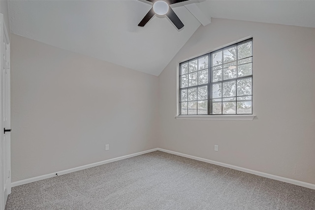 empty room with carpet floors, ceiling fan, and vaulted ceiling with beams