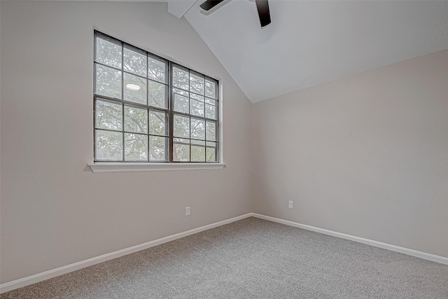 empty room featuring ceiling fan, lofted ceiling, and carpet