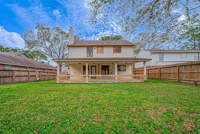 back of property with a lawn