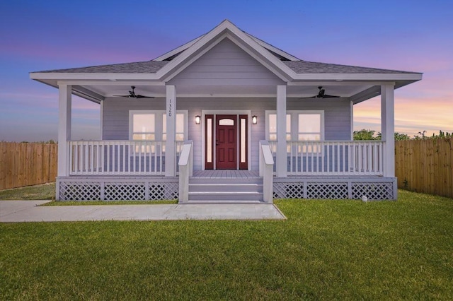 view of front facade featuring a yard, covered porch, and ceiling fan