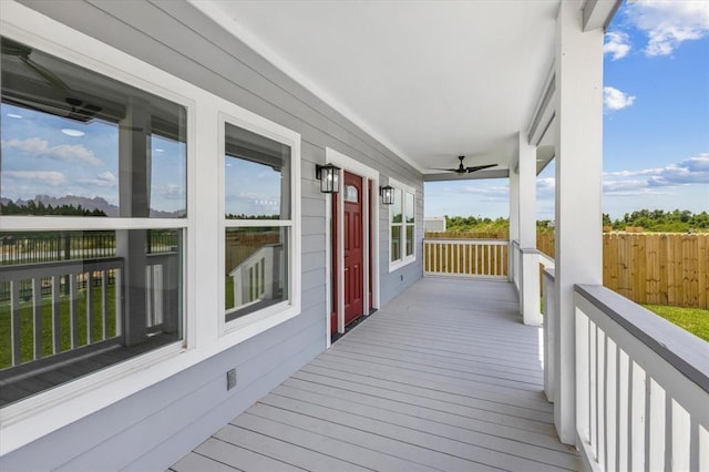 wooden deck featuring ceiling fan