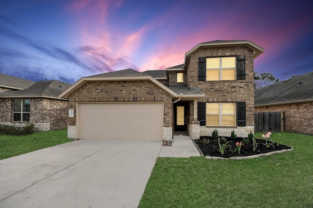 view of front of house with a garage and a lawn