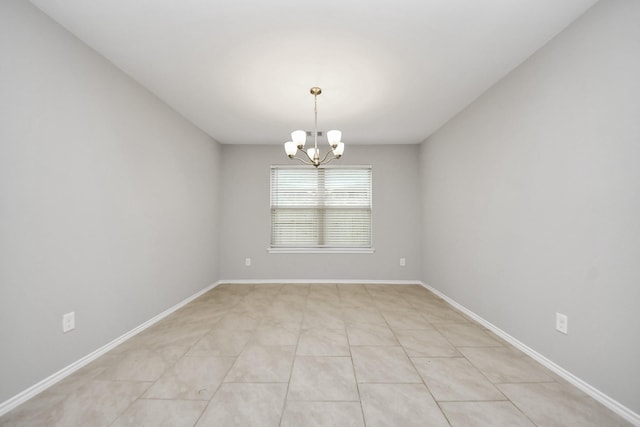 tiled empty room with a chandelier