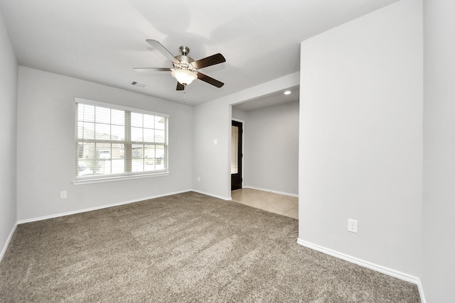 unfurnished room featuring ceiling fan and carpet