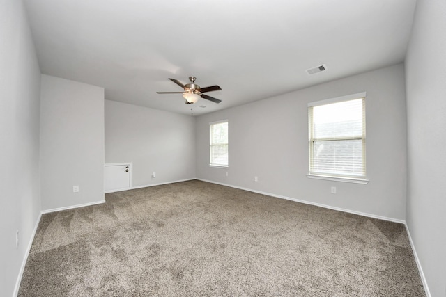 empty room with carpet floors and ceiling fan