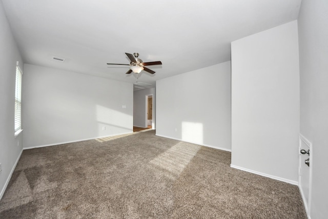 spare room with ceiling fan and carpet