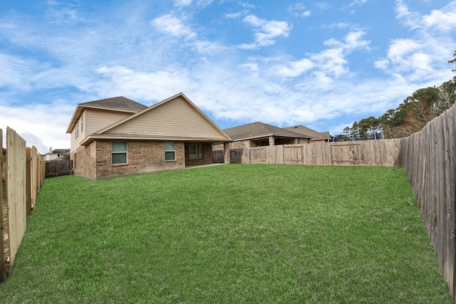 rear view of property featuring a lawn