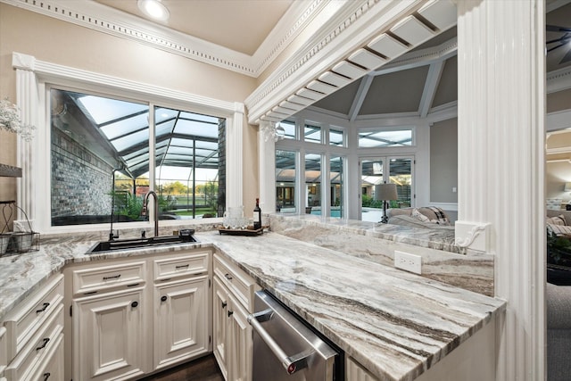 kitchen with sink, light stone countertops, and white cabinetry