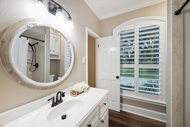 bathroom featuring hardwood / wood-style flooring, toilet, walk in shower, vanity, and crown molding