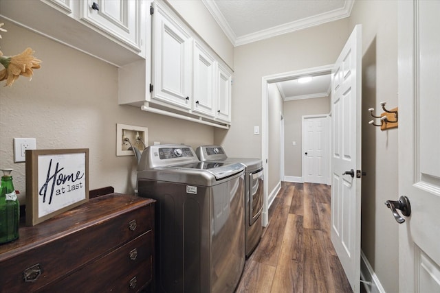 clothes washing area featuring cabinets, independent washer and dryer, crown molding, dark wood-type flooring, and a textured ceiling