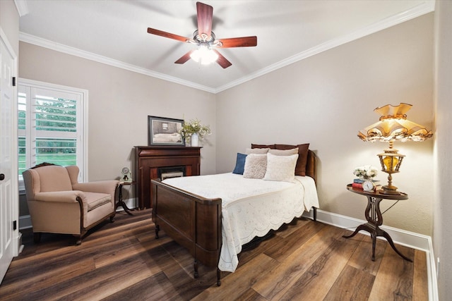 bedroom featuring dark hardwood / wood-style flooring, ceiling fan, and crown molding