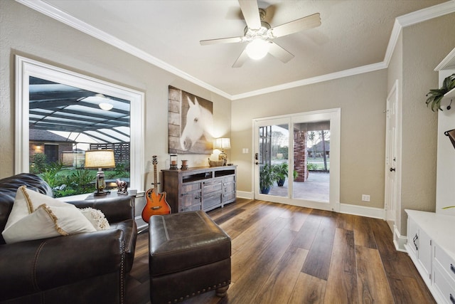 living area featuring dark wood-type flooring, ceiling fan, and ornamental molding