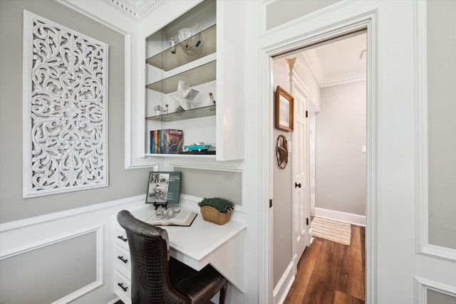 interior space with built in features, crown molding, and dark hardwood / wood-style floors