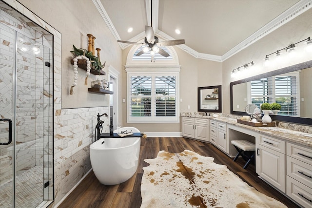 bathroom with independent shower and bath, crown molding, vanity, and wood-type flooring