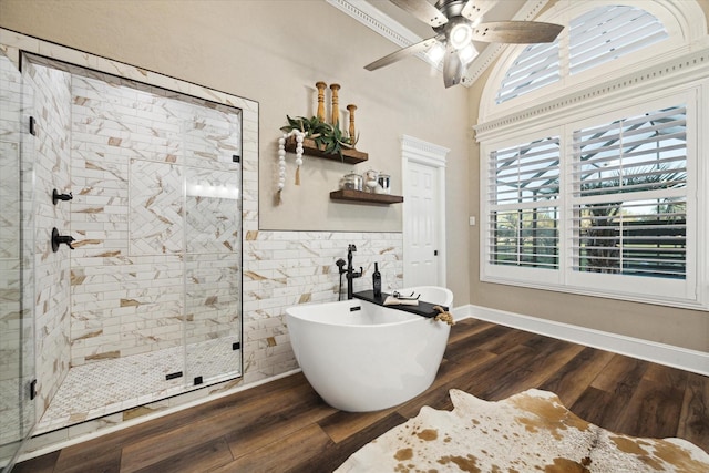 bathroom featuring shower with separate bathtub, hardwood / wood-style floors, and ceiling fan